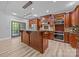 Spacious kitchen featuring cherry cabinets, large center island, stainless appliances, and stylish light fixtures at 11280 Mcfalls Dr, Fort Mill, SC 29707