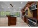 Bright kitchen boasting stainless steel appliances, custom wood cabinetry and an island with seating at 11280 Mcfalls Dr, Fort Mill, SC 29707