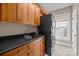 Functional laundry room featuring updated cabinets, a sink, and stacked washer/dryer, with a window view at 11280 Mcfalls Dr, Fort Mill, SC 29707