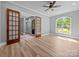 Bright living room featuring hardwood floors, large windows, wood trim and doors, and neutral paint at 11280 Mcfalls Dr, Fort Mill, SC 29707