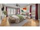 Luxurious main bedroom with large windows, elegant furnishings, and a cozy atmosphere at 11280 Mcfalls Dr, Fort Mill, SC 29707