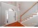 Welcoming foyer boasts hardwood floors, staircase, natural light, and a white front door at 13344 Craig Mill Ln, Huntersville, NC 28078