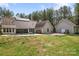 Large backyard with a patio, lush greenery, and exterior view of the home and detached garage at 1485 Sierra Rd, York, SC 29745