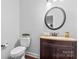 Well-lit bathroom with a decorative mirror, dark wood vanity, and light brown countertop at 1485 Sierra Rd, York, SC 29745