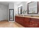 Bathroom featuring double vanity with granite countertop, and dark wood cabinets and framed mirrors at 1485 Sierra Rd, York, SC 29745