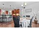 Open dining room with wood floors, chandelier, and views of the kitchen at 1485 Sierra Ln, York, SC 29745