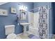 The bathroom has a shower over the bath, a pedestal sink, and blue walls at 150 Canopy Oak Ln, Statesville, NC 28625