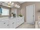 Bathroom featuring a double sink vanity with a large mirror and modern fixtures at 150 Canopy Oak Ln, Statesville, NC 28625