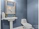 Charming powder room featuring a pedestal sink and toilet at 150 Canopy Oak Ln, Statesville, NC 28625