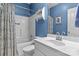 This is a bathroom with a shower over the bath, a shelf, and a mirror above the sink at 150 Canopy Oak Ln, Statesville, NC 28625