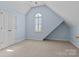 Airy bedroom showcasing an arched window, double-door closet, and neutral carpet for a serene and bright living space at 150 Canopy Oak Ln, Statesville, NC 28625