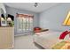 This bedroom has a large window with shutters and a dresser, and a bed with a decorative bedspread at 150 Canopy Oak Ln, Statesville, NC 28625