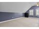 Spacious bedroom with a sloping ceiling, two windows, neutral carpet, and plenty of room for versatile use at 150 Canopy Oak Ln, Statesville, NC 28625