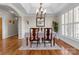 Elegant dining room with wainscoting, hardwood floors, and a stylish chandelier at 150 Canopy Oak Ln, Statesville, NC 28625