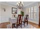 Elegant dining room with wainscoting, hardwood floors, and a stylish chandelier at 150 Canopy Oak Ln, Statesville, NC 28625