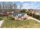 Charming brick home featuring a manicured lawn, complemented by mature trees and inviting curb appeal at 150 Canopy Oak Ln, Statesville, NC 28625