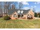 Charming brick home with a well-manicured front lawn and traditional design elements at 150 Canopy Oak Ln, Statesville, NC 28625