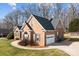 Well-maintained brick home features an attached garage and a landscaped yard at 150 Canopy Oak Ln, Statesville, NC 28625