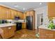Eat-in kitchen featuring wood cabinets, stainless steel appliances, hardwood floors and recessed lighting at 150 Canopy Oak Ln, Statesville, NC 28625