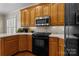 Eat-in kitchen featuring wood cabinets, stainless steel appliances, hardwood floors and recessed lighting at 150 Canopy Oak Ln, Statesville, NC 28625