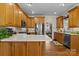 Spacious eat-in kitchen with light countertops, stainless steel appliances and hardwood floors at 150 Canopy Oak Ln, Statesville, NC 28625