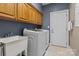 Functional laundry room equipped with washer, dryer, sink and ample cabinet storage at 150 Canopy Oak Ln, Statesville, NC 28625