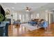 Spacious living room with hardwood floors, fireplace, ceiling fan, and ample natural light at 150 Canopy Oak Ln, Statesville, NC 28625