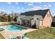 This backyard features a fenced pool, patio, and lush lawn, creating a perfect oasis for relaxation and entertainment at 150 Canopy Oak Ln, Statesville, NC 28625