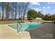 Backyard pool with a diving board, lounge chairs, and patio area is perfect for summer relaxation and entertainment at 150 Canopy Oak Ln, Statesville, NC 28625