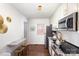 Well-equipped kitchen with stainless steel appliances, white cabinets, and a breakfast bar at 1857 Brownstone St, Charlotte, NC 28216