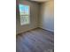 Bright bedroom with modern floors and natural light from the window at 195 Bethesda Rd, Statesville, NC 28625