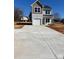 Charming two-story home with light siding, garage and a concrete driveway at 195 Bethesda Rd, Statesville, NC 28625