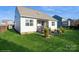 The backyard features a covered porch, patio, and lush lawn with privacy fencing at 2112 Balting Glass Dr, Indian Trail, NC 28079