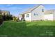Well-maintained backyard with a patio, green lawn, and exterior view of the home at 2112 Balting Glass Dr, Indian Trail, NC 28079