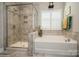 A well lit bathroom with a separate shower and soaking tub combo at 2112 Balting Glass Dr, Indian Trail, NC 28079
