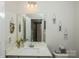Bright bathroom featuring a mirror, modern vanity, and stylish decorations at 2112 Balting Glass Dr, Indian Trail, NC 28079