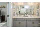 The bright bathroom features a double vanity, large mirror and tiled wall at 2112 Balting Glass Dr, Indian Trail, NC 28079