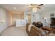 Upstairs bonus room with carpet, ceiling fan, comfortable furniture, and natural light at 2112 Balting Glass Dr, Indian Trail, NC 28079