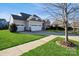 Charming home with a manicured lawn, a two-car garage, and stone accents at 2112 Balting Glass Dr, Indian Trail, NC 28079