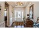 Bright foyer with hardwood floors, decorative light fixtures, and white trim at 2112 Balting Glass Dr, Indian Trail, NC 28079