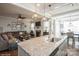 A spacious living room with a fireplace and large windows showcases the kitchen island at 2112 Balting Glass Dr, Indian Trail, NC 28079