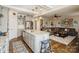 An open-concept living room flows into the kitchen with a large island and hardwood floors at 2112 Balting Glass Dr, Indian Trail, NC 28079