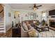 Inviting living room featuring a large sectional sofa, hardwood floors, and natural light at 2112 Balting Glass Dr, Indian Trail, NC 28079