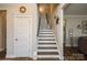 Stairway to the second floor with white trim, wood steps, and natural light at 2112 Balting Glass Dr, Indian Trail, NC 28079
