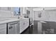 Modern kitchen features stainless steel appliances, white cabinets, quartz countertops, and dark hardwood floors at 2123 Ravendale St, Kannapolis, NC 28083