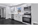 Modern kitchen with sleek stainless steel appliances, white cabinetry, and dark hardwood floors at 2123 Ravendale St, Kannapolis, NC 28083
