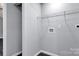 Laundry area with white wire shelving, washer/dryer hook-ups and seamless flooring at 2123 Ravendale St, Kannapolis, NC 28083