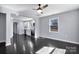 Open-concept living space with hardwood floors connecting to a modern kitchen with stainless steel appliances at 2123 Ravendale St, Kannapolis, NC 28083
