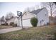 View of the home's exterior with an attached garage, basketball hoop, and tidy landscaping at 2345 Nuthatch Dr, Rock Hill, SC 29732