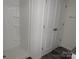 Shower with built in storage and white double door storage in the bathroom at 252 Mills Ave, Troutman, NC 28166